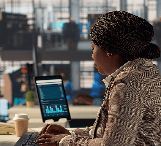 Business professional reviewing analytics on laptop